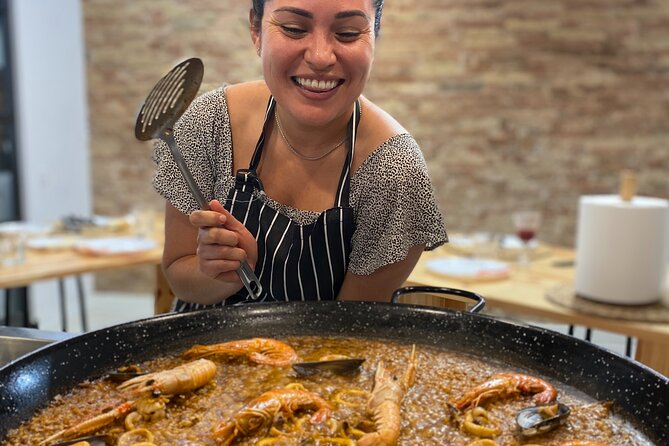 Barcelona Paella Cooking Class & Boqueria & Hofmann-Trained Chefs - Making seafood paella over open flames