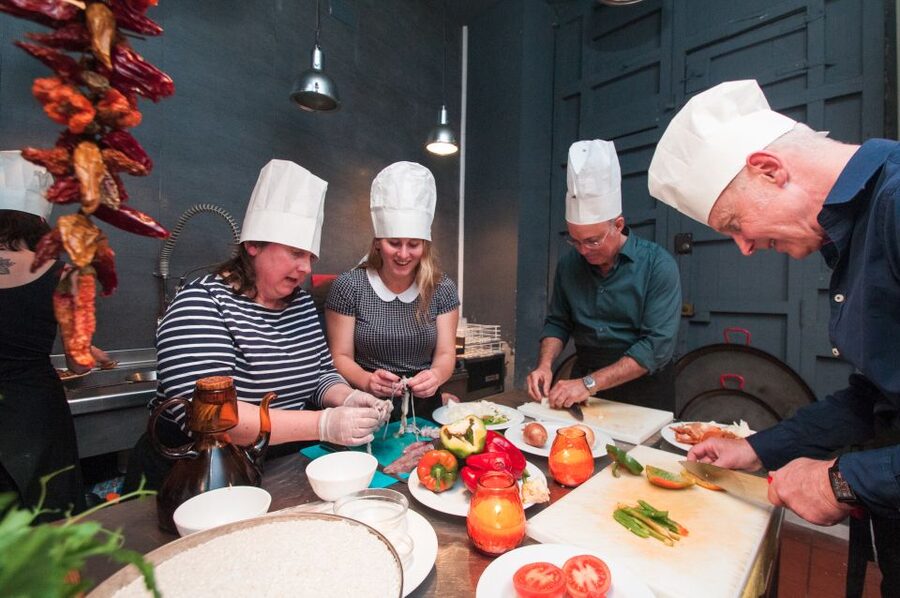 Barcelona: Paella Cooking Experience & Boqueria Market Tour - Taking your place around the paellera