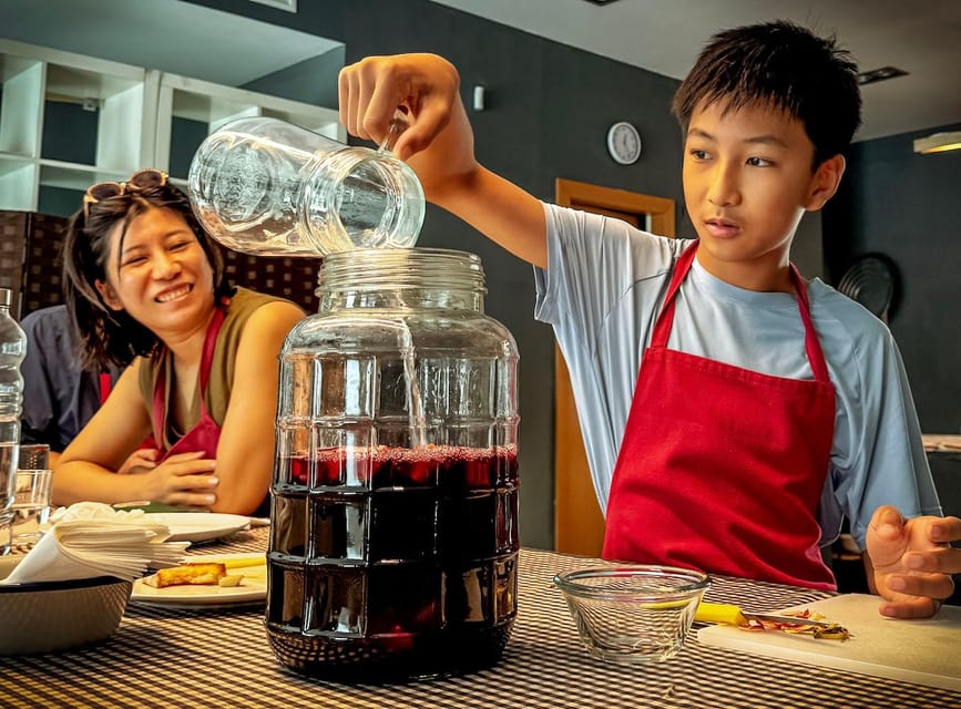 Barcelona: Seafood Paella ★Maestro★ & Tapas & Sangria - Making sangria from fresh fruit