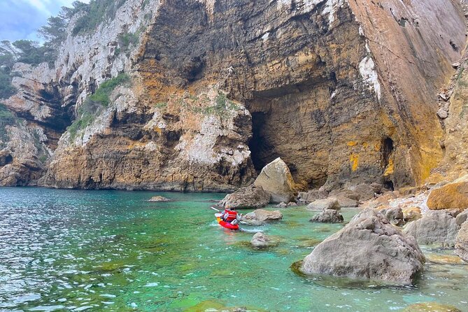 Kayak Paradise: Cala Portixol Snorkel, Cave & Cliff Jumping Tour - Cap Negre, a 100-meter wall of stone