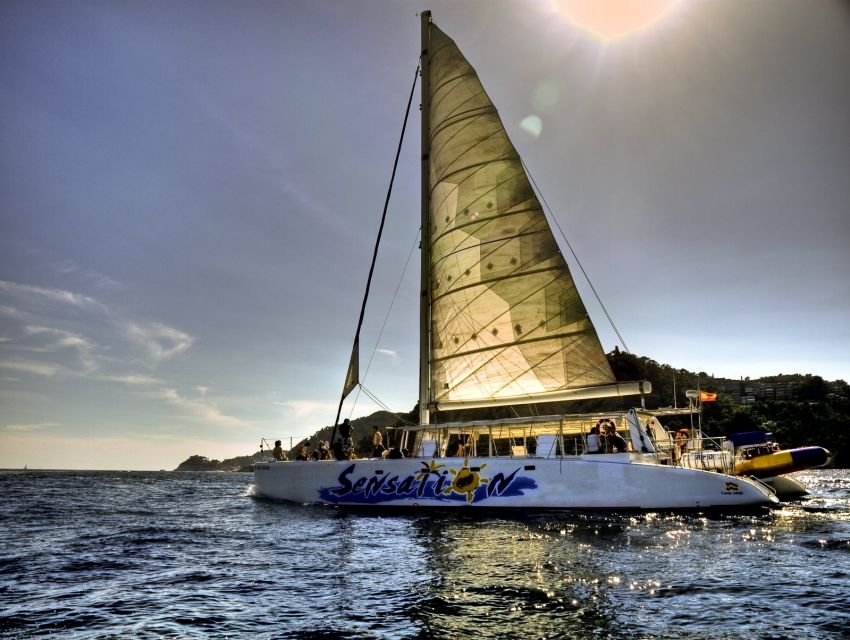 Lloret de Mar: Sunset Catamaran Cruise with DJ and Drinks - The DJ, drinks, and party mood