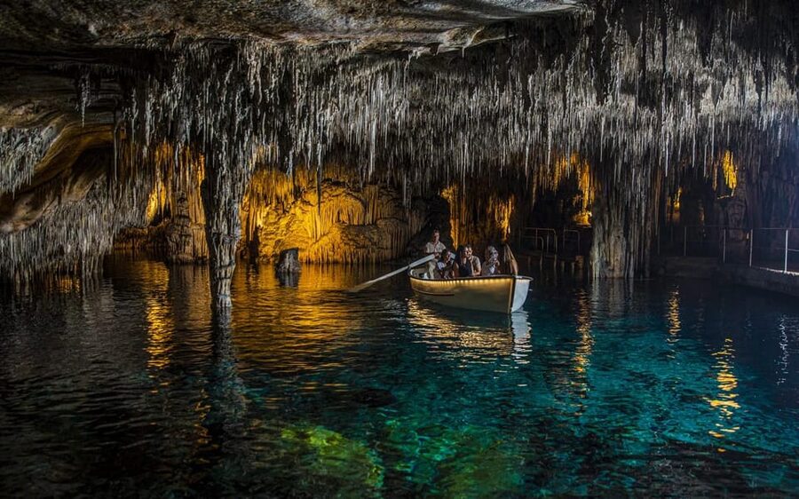 Palma: Caves of Drach Entrance, Music Concert, and Boat Trip - Walking through the illuminated cave chambers