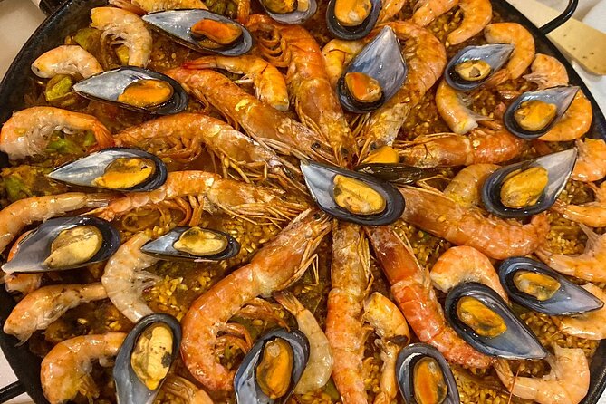 Seville: Paella Showcooking Experience - Starting with olives, cheese, and Iberian chacina
