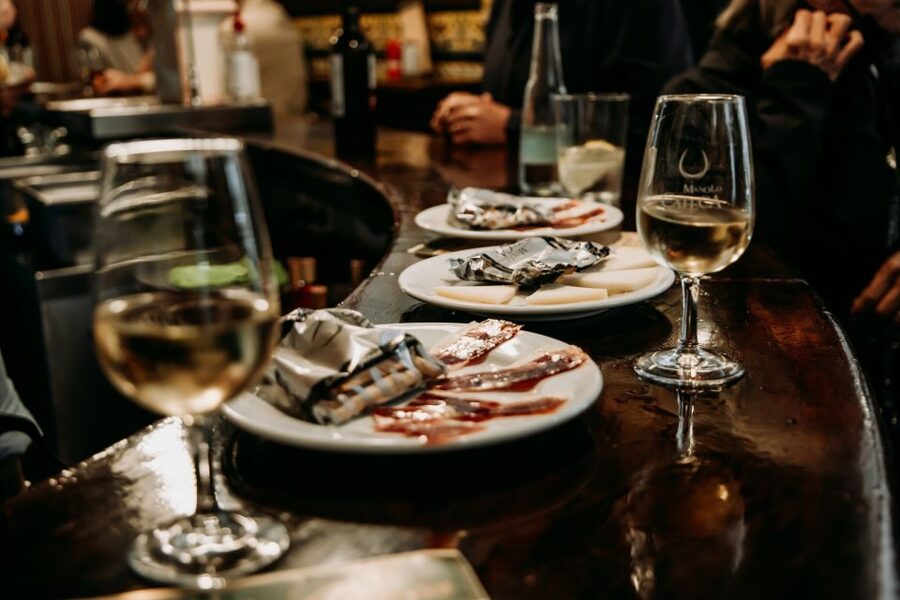 Seville: Tapas, Taverns, and History Walking Tour - Entering the Seville bar that opened in 1942